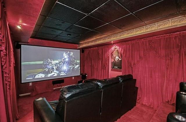 Amazing movie theater room with stadium seating and a 10 foot Screen!