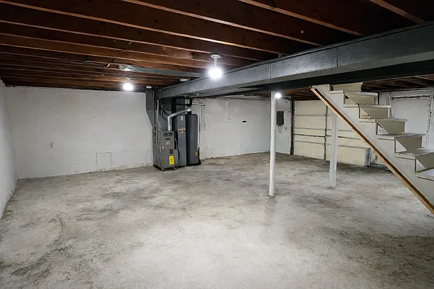 Spacious unfinished basement offering excellent storage, workshop, home gym, or flex space.