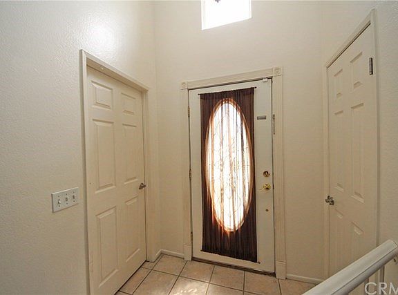 Formal entryway with a coat closet