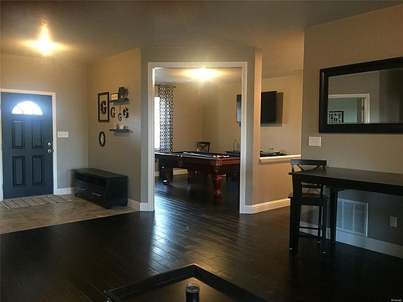 Looking into the formal dining room from the living room which doubles as a recreation room.
