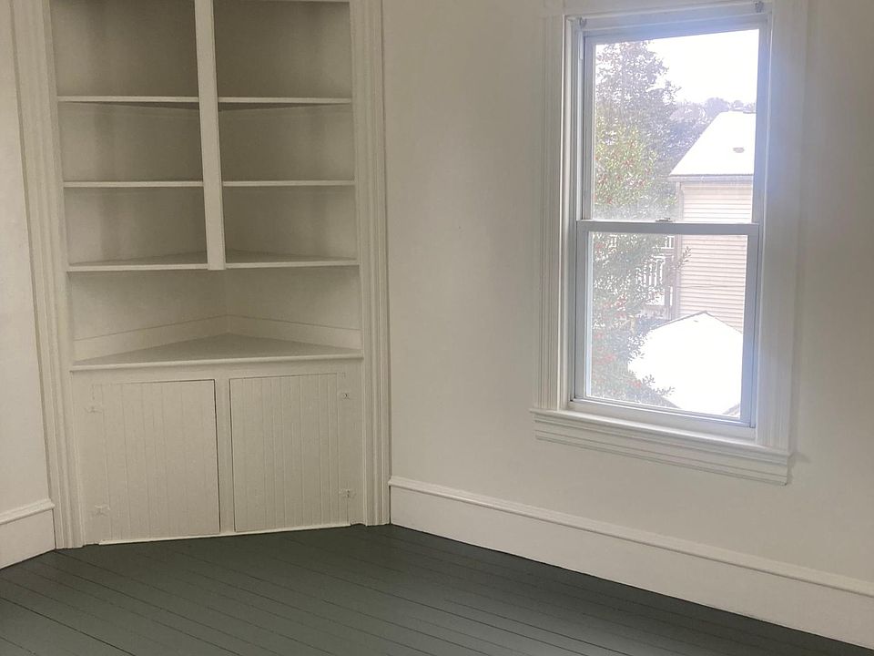 Bedroom 1 with built-in shelving and cabinets