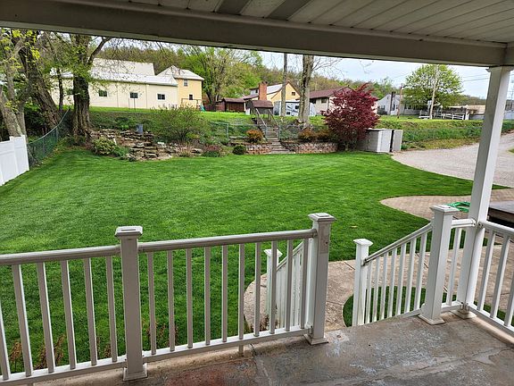 View of the backyard. The bike trail is located above the embankment.