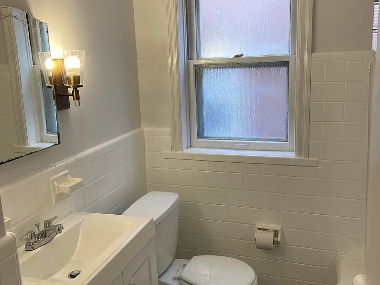 Bathroom with medicine cabinet, tub, and shower.