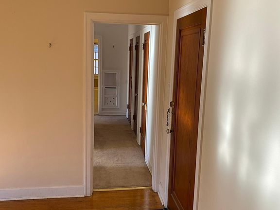 Front entry door and hallway to bedroom, bath, and backdoor