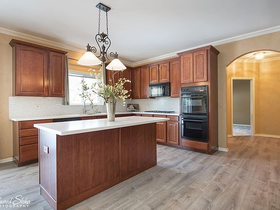 GORGEOUS KITCHEN WITH CUSTOM CHERRY CABINETS, STUNNING BACKSPLASH AND ISLAND