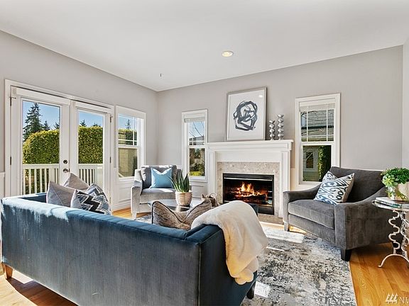 Living room with wonderful fireplace opens directly onto the view deck which overlooks Wing Point's 17th Fairway!