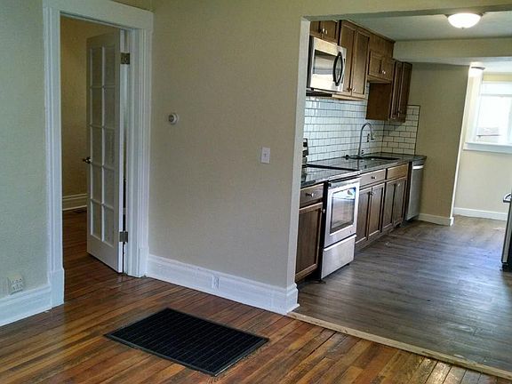 Living room looking into kitchen and bedroom