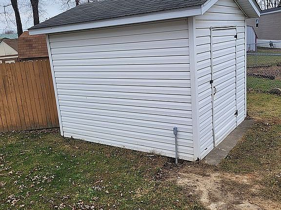 Large wired storage shed in backyard