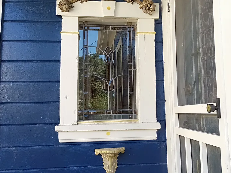 Kitchen Stained glass Window at the entry looking out to the front entry porch garden.