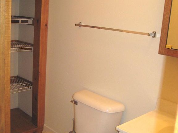 main floor 1/2 bath with closet shelving