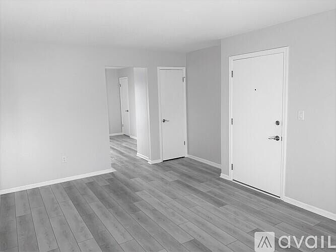 Living room showing entry door with view into kitchen.