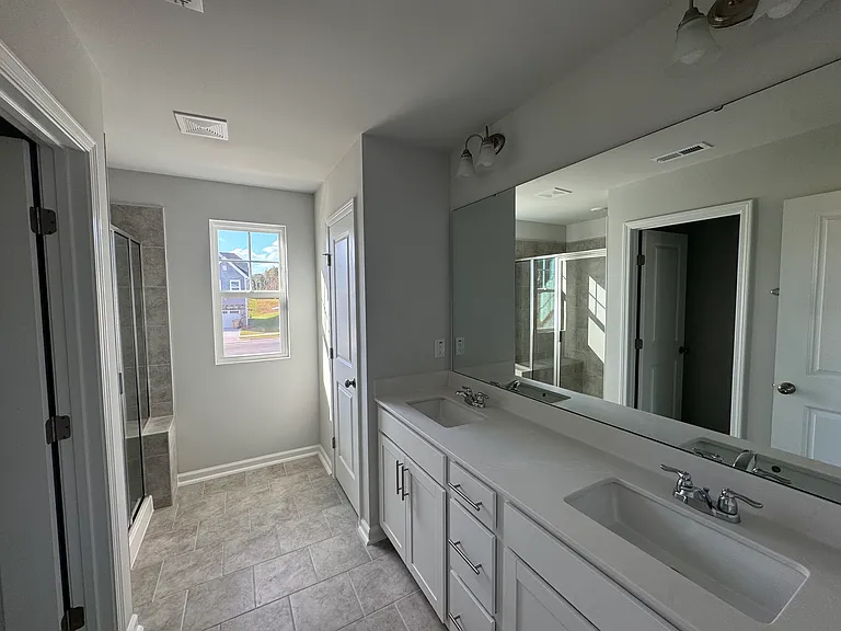 Primay bathroom with dual vanities