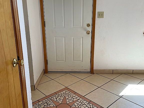 Mosaic tile by front door.