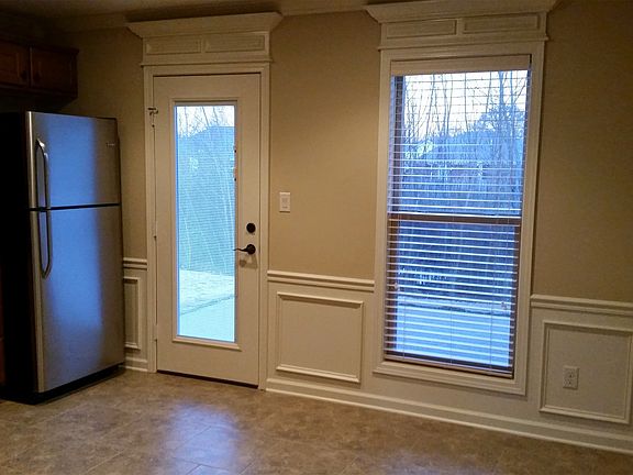 Kitchen/dining & living areas with built in blinds & crown a