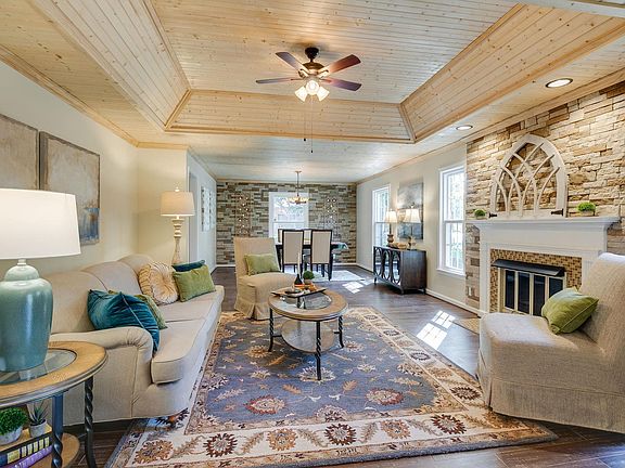 Great room with fireplace, new gas logs, hardwood flooring, beadboard ceiling, stone surround fireplace