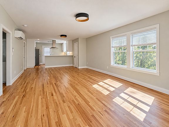 Sunlit Modern Open-Plan Living Space with coat closet