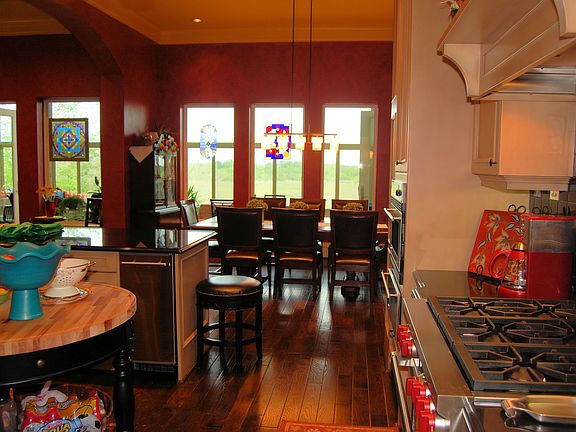 Chef's kitchen overlooks delightful dining room.