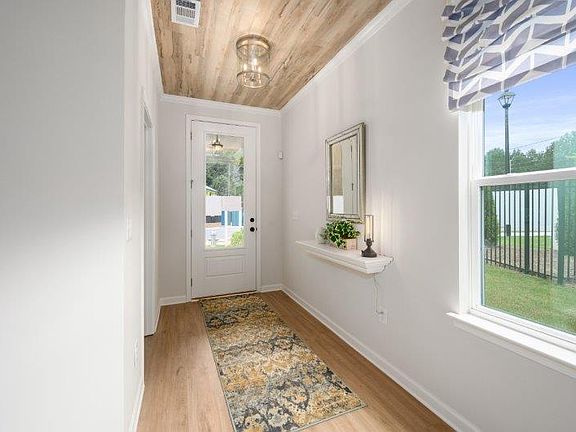 Foyer with unique details Photo is a representation of home.