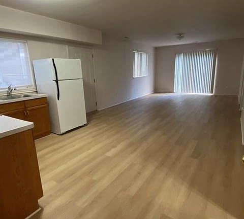 Open space...Kitchen and living room. Kitchen has electric stove and refrigerator. New flooring!