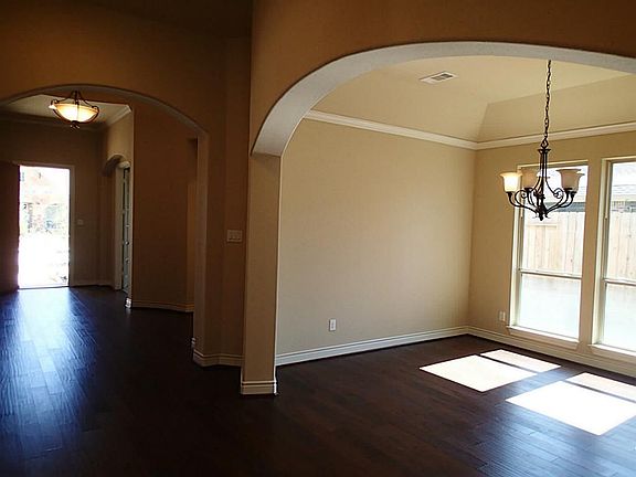 Formal dining with wood floors & crown molding.