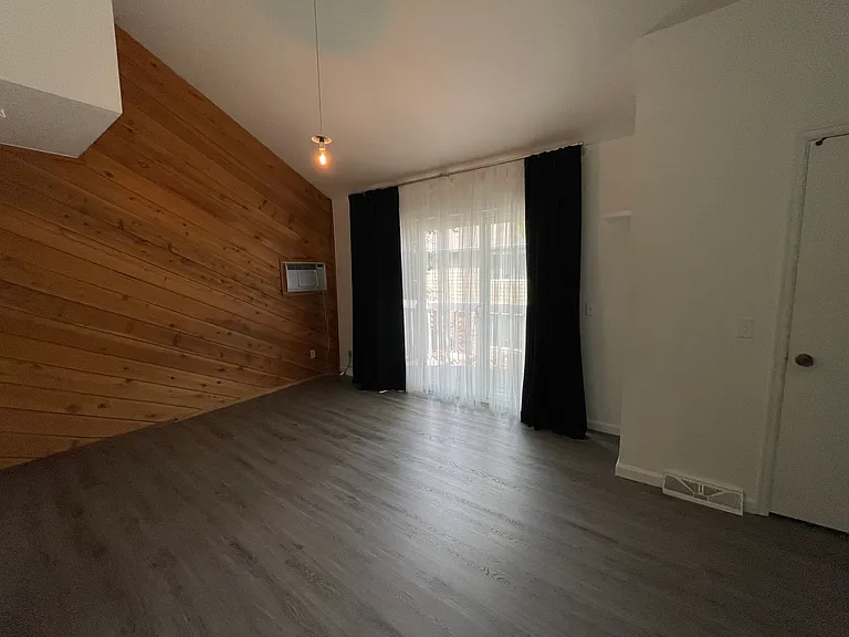 Master bedroom with large sliding door and walk-in closet.