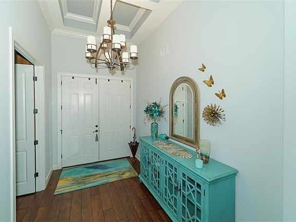 Fine details throughout include coffered & tray ceilings, crown molding, surround sound, security cameras & custom plantation sh