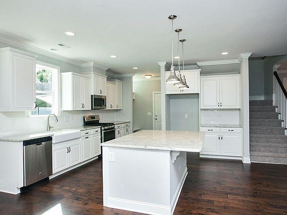Huge kitchen with a walk-in pantry behind the fridge (included). Door on left leads to 2-car garage. Note: refrigerator is not shown in this photo, but it is included!