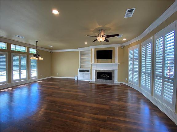 Planation shutters throughout with custom built-ins. The fireplace can host gas-logs or wood burning!