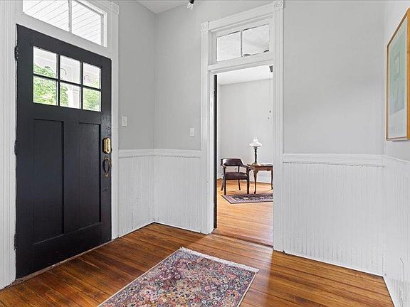 Foyer opens to the living room to the left and kitchen straight ahead