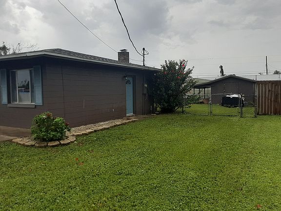 Right side of home from Letohatchee Street with view of fence and shop.