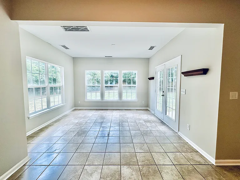 Huge sunroom overlooking the backyard and patio