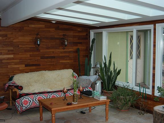 Solarium decked out with solid Teak walls, travertine floors and lots of glass