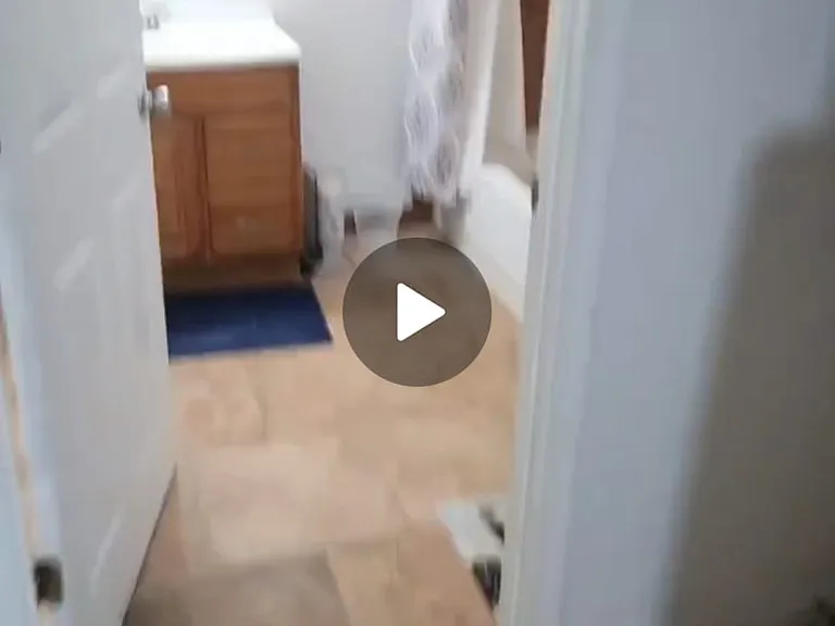 this photo shows the interior hallway entry entering the full size shared bathroom with laundry closet which is also shared. each of the bedrooms connects to this shared hallway