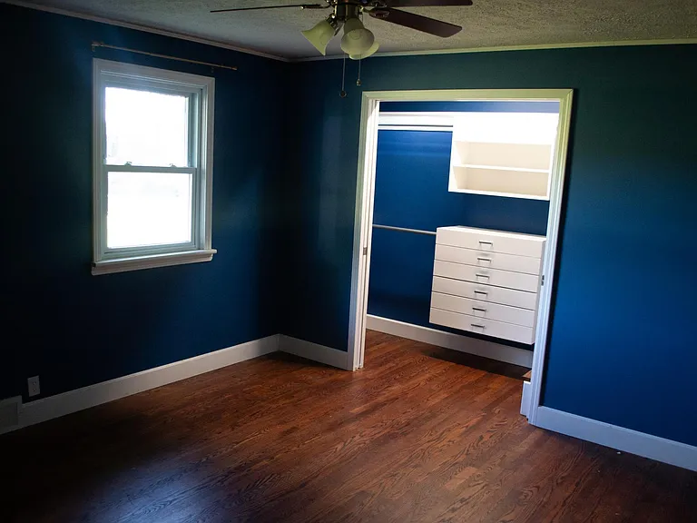 Bedroom 1 with walk-in closet unit.
