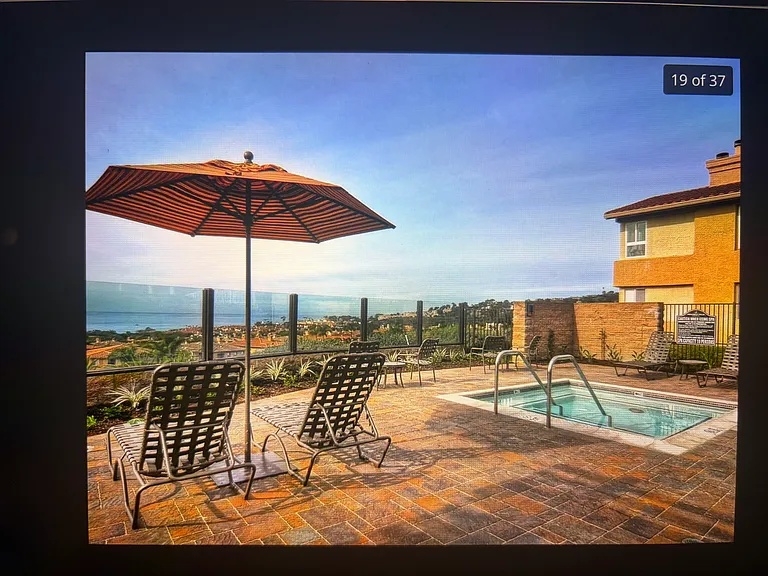 Penthouse-adjacent spa with breathtaking sunset glow. Community. Our penthouse side living room window in the background. Top floor-NO STAIRS from parking lot.