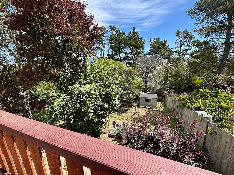 Private deck off of primary bedroom, overlooking backyard.