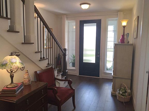 Entry into the home. Enjoy the spacious three story foyer with room for furniture. Wood floor.