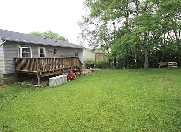 LEVEL FENCED YARD W/ DECK AND PATIO.