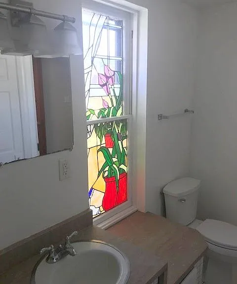 4ft custom Stained Glass in bathroom with custom 2 tier marble vanity.