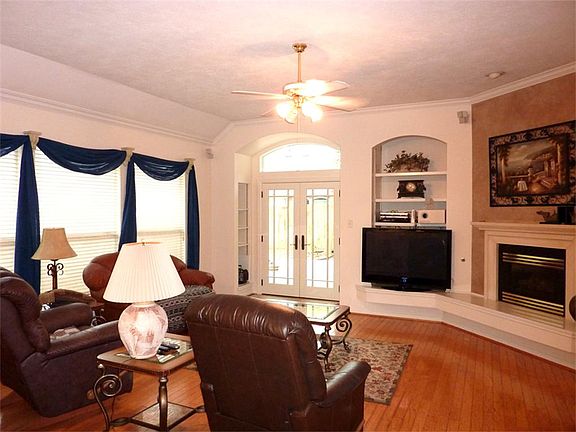 Spacious Living Area with Wood Floors and French Doors to the Backyard Deck.