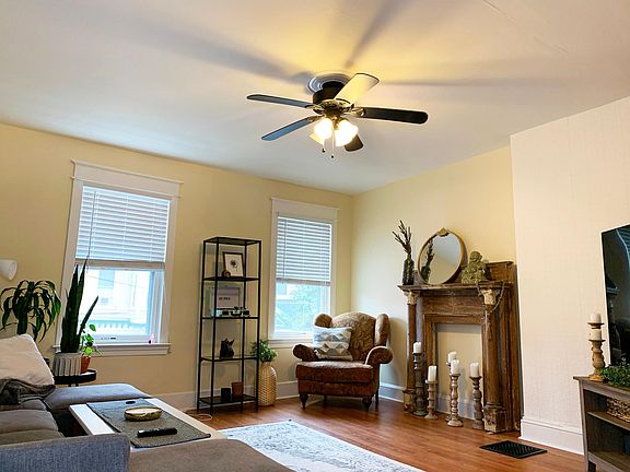 The Living room has hardwood floors, two-inch blinds, a decorative ceiling fan, and is cable and internet ready.