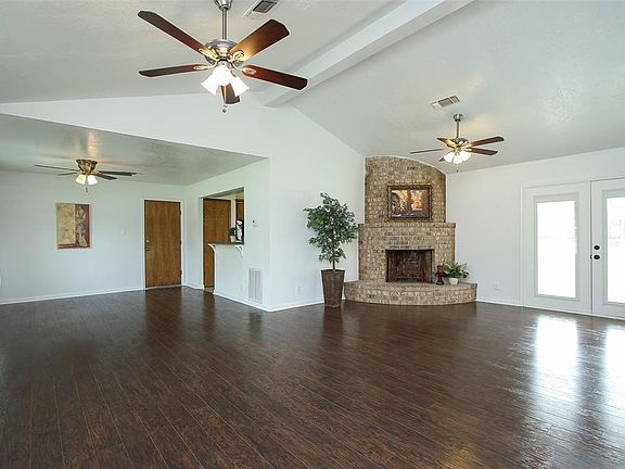 Spacious living area with French doors leading to back patio.