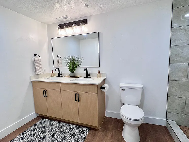 Shared bathroom with glass door.