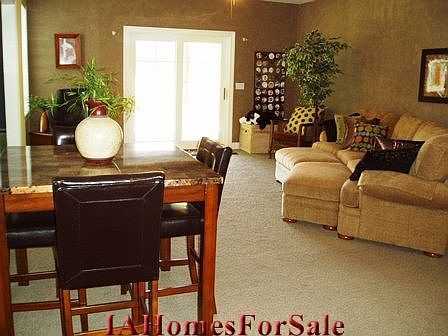 The lower-level family room is flanked by three huge additional bedrooms, loads of storage areas, a full bath, and steps leading up to the garage area for private entry.