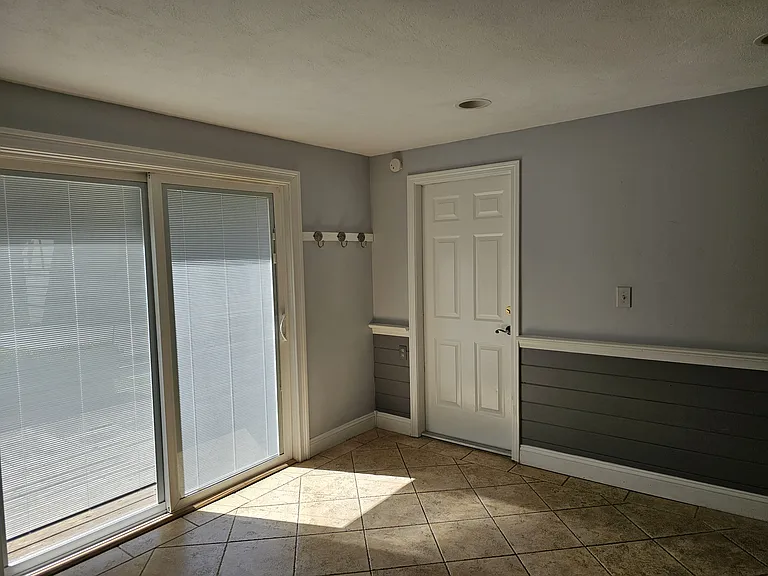 Main Level - Dining room with entrance from garage. Glass doors access to the backyard