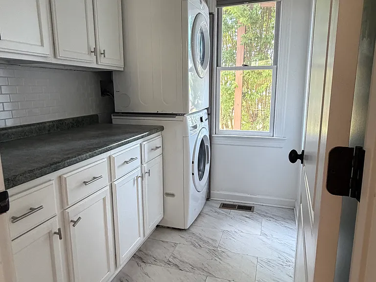Separate dedicated laundry room with tons of built-in cabinetry _ keep detergents, linens and cleaning supplies organized and out of sight.