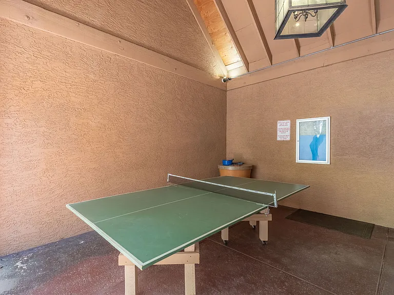 Ping pong located by the locker rooms by the big pool