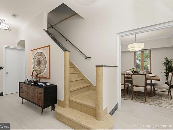 The entry hall has a small foyer. The opening leads to the dining room
