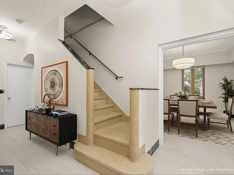 The entry hall has a small foyer. The opening leads to the dining room