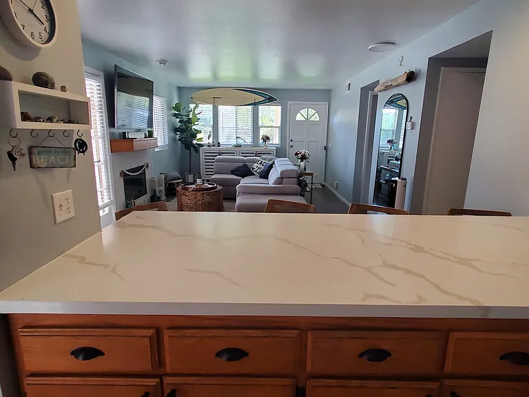 Quartz breakfast bar, kitchen cabinets, & Livingroom